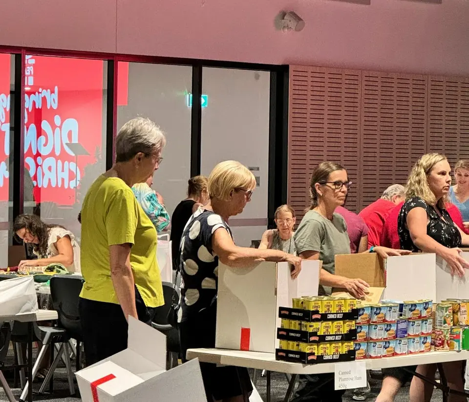 Volunteers packing Parcels of Peace Christmas hampers