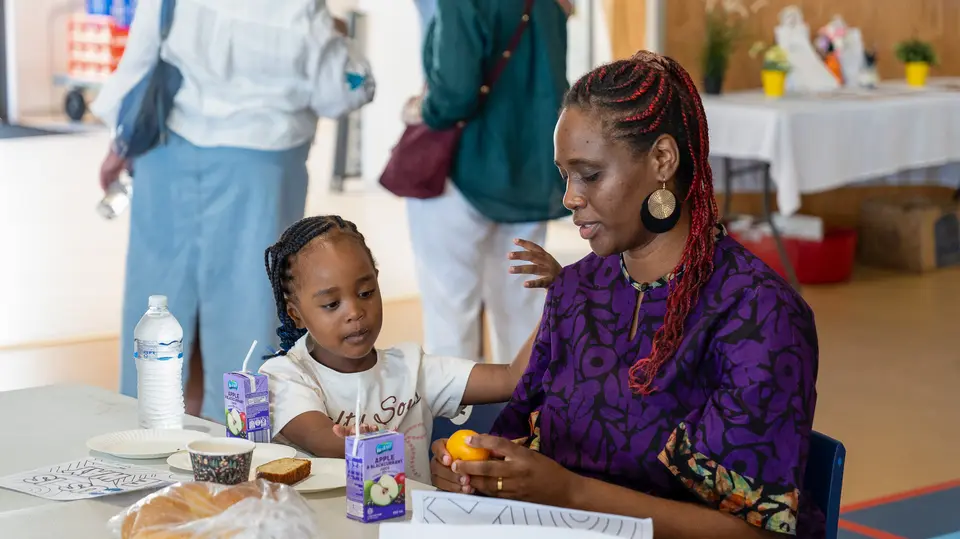 A mum and daughter sharing a meal at a Rhythm community lunch