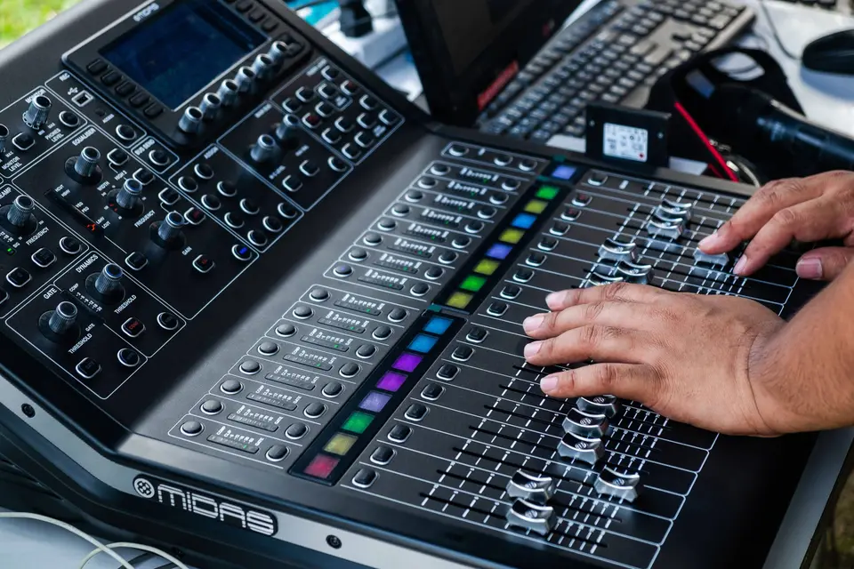 A volunteer running the sound desk on a Sunday